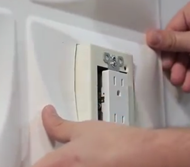 placing-wall-panel-over-electical-outlet-extenders